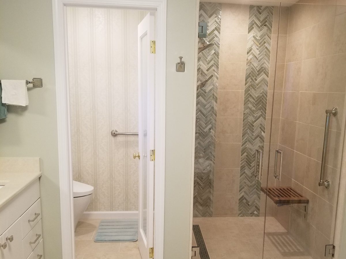 Guest bathroom with toilet and glass shower enclosure