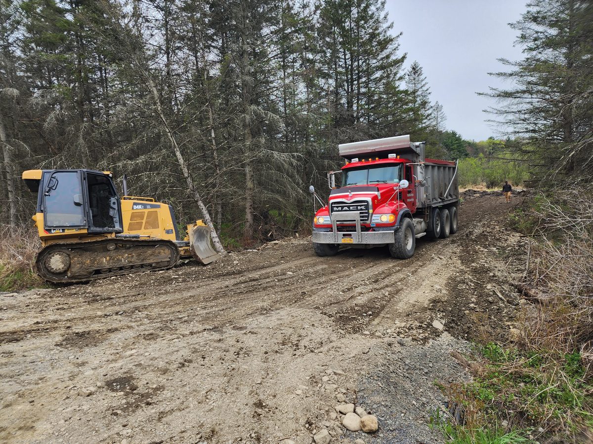 Driveway grading with a dozer and dump truck
