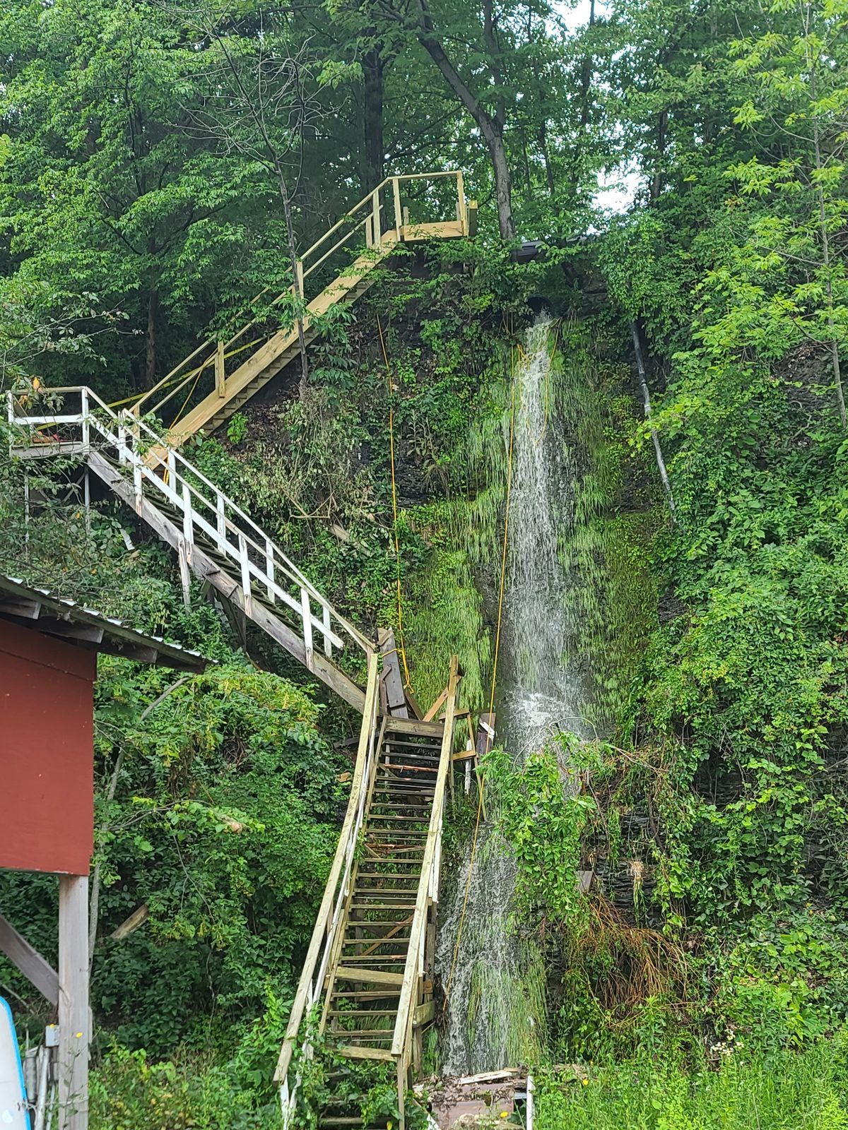 The original weathered stairs beside the waterfall, before replacement