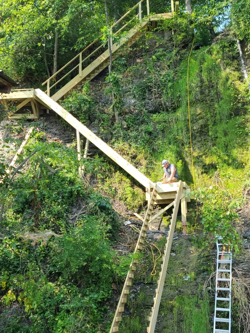 Landing framing partway up the run, with the cliff face behind