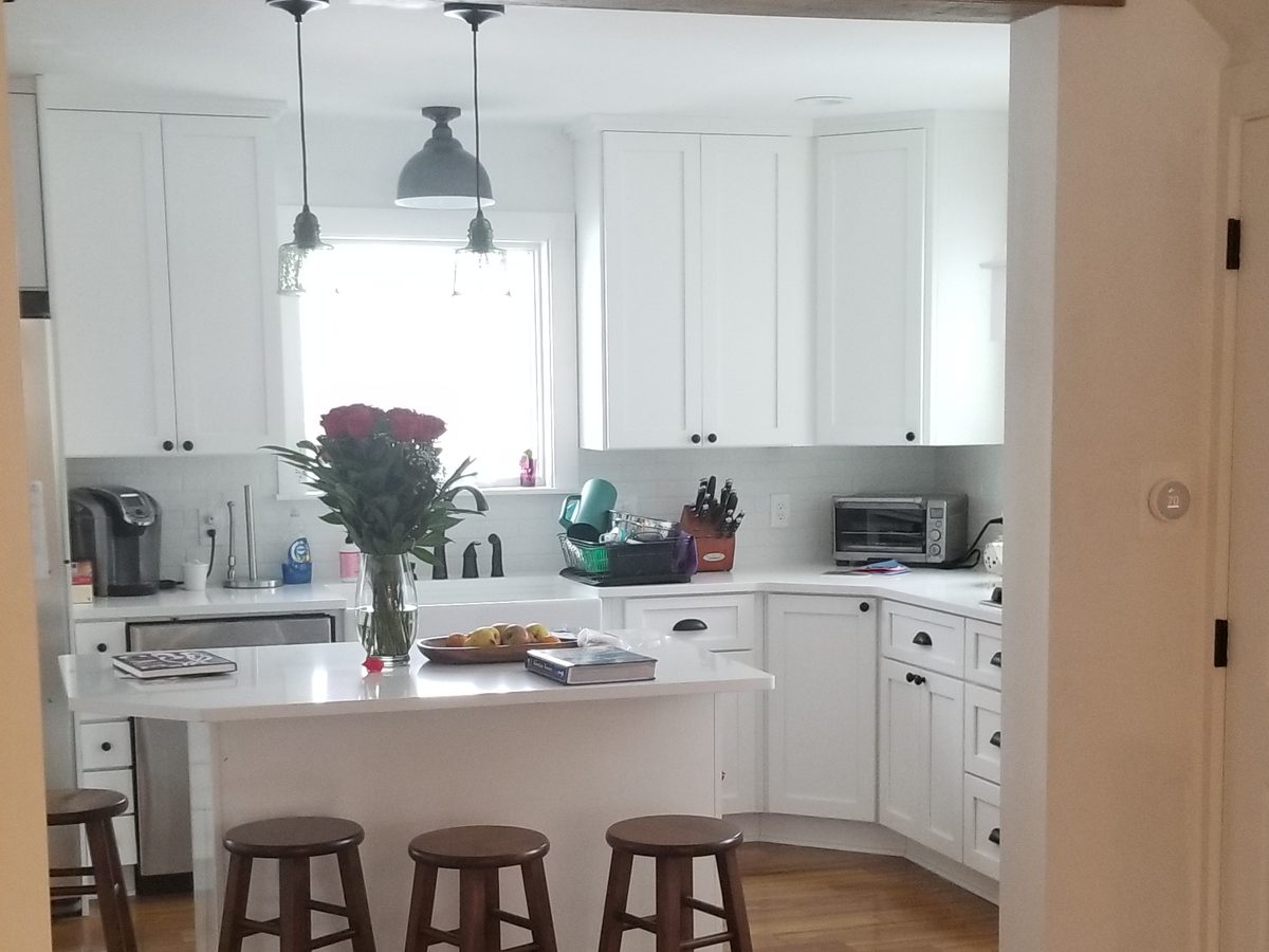 Kitchen view through reclaimed wood beam