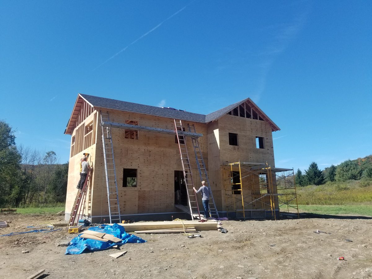 Two story home in the Finger Lakes region, sheathed with the roof going on