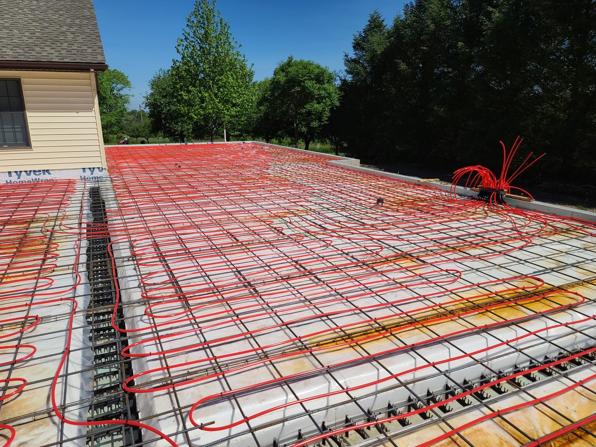 Radiant floor tubing laid over slab prep