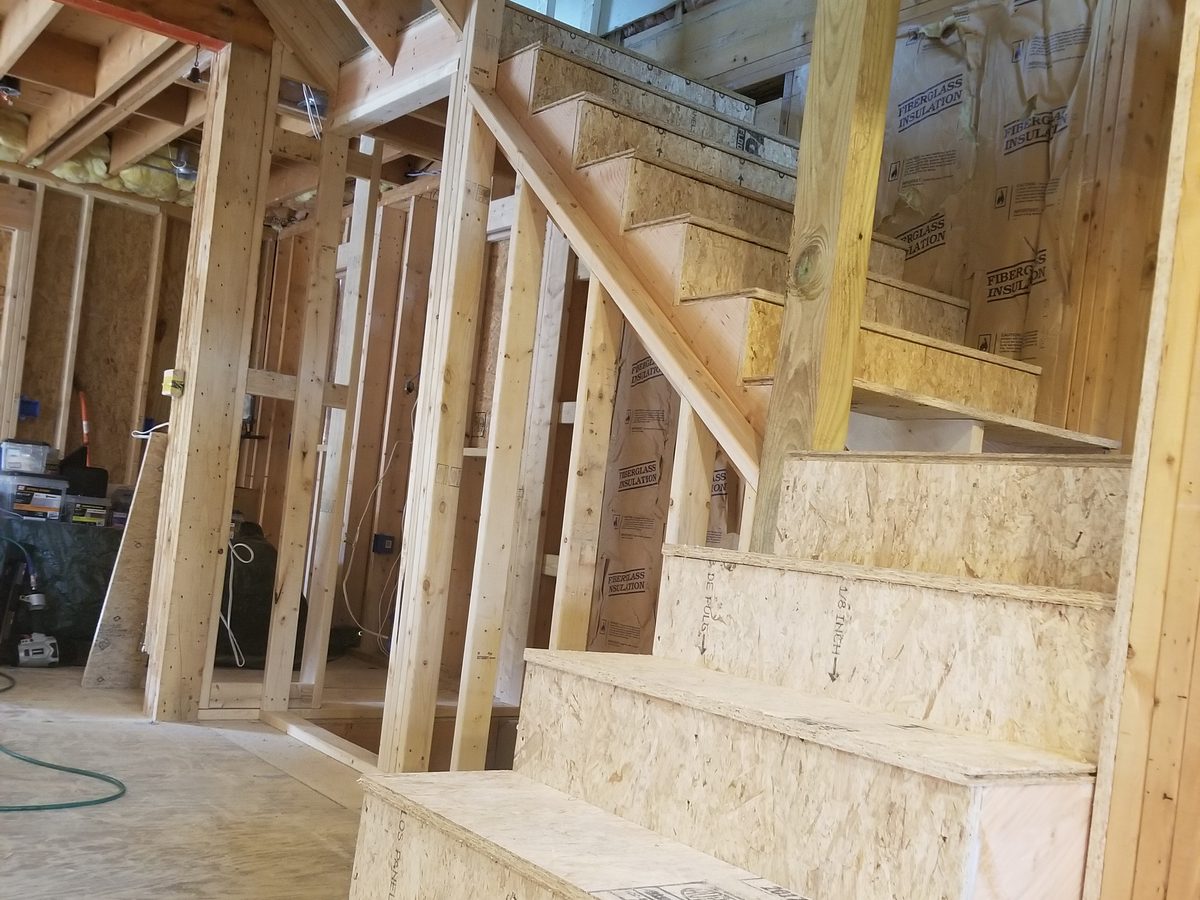 Staircase framed with OSB treads, insulated wall behind