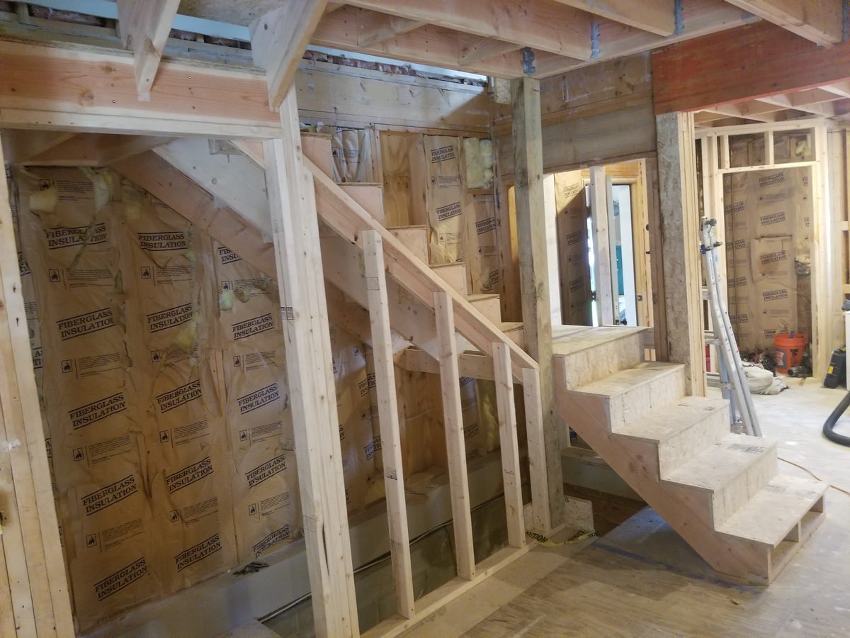 Wider view of the framed stair run and open stud walls